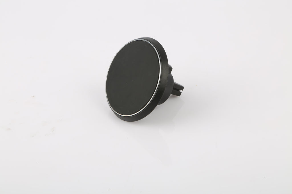 A black circular car dashboard mount with a magnetic surface and a small protruding clip, shown on a plain white background.